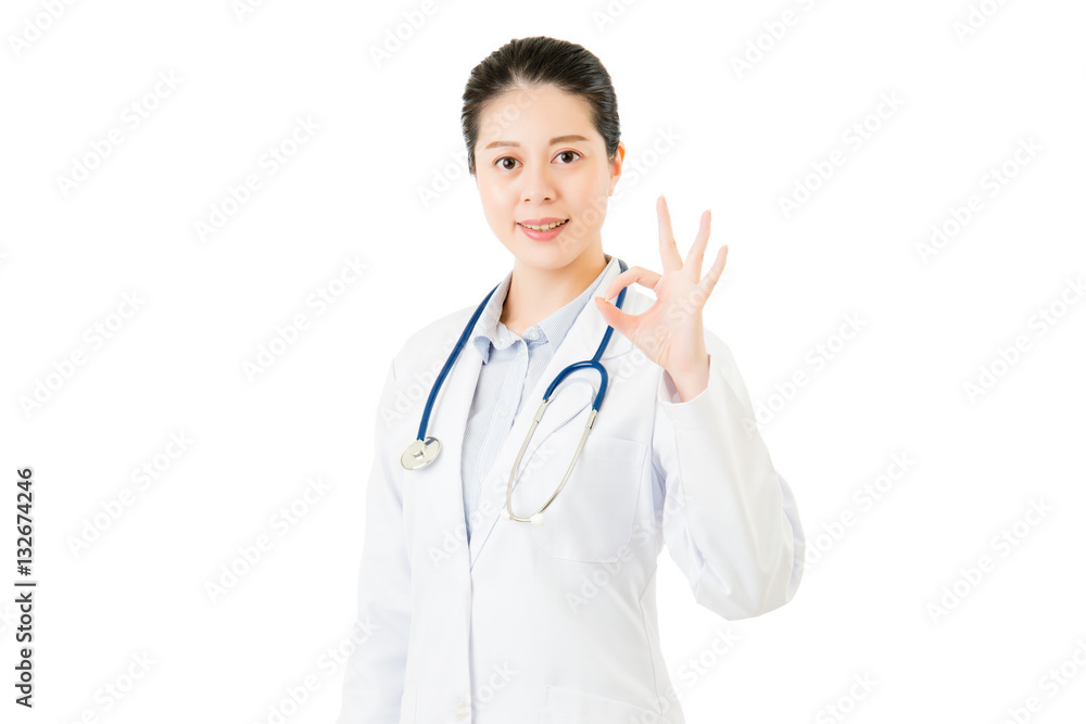 Smiling asian woman doctor with stethoscope showing ok gesture Smiling asian woman doctor with stethoscope showing ok gesture