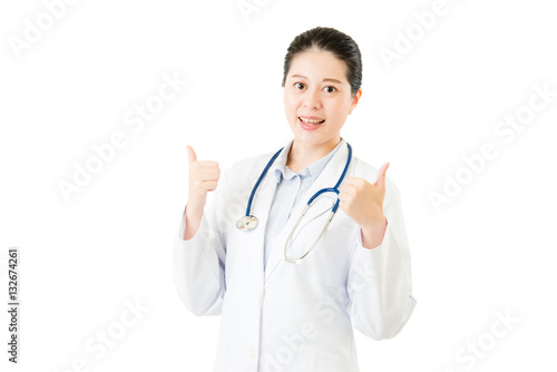 Smiling asian doctor woman with stethoscope show thumb up