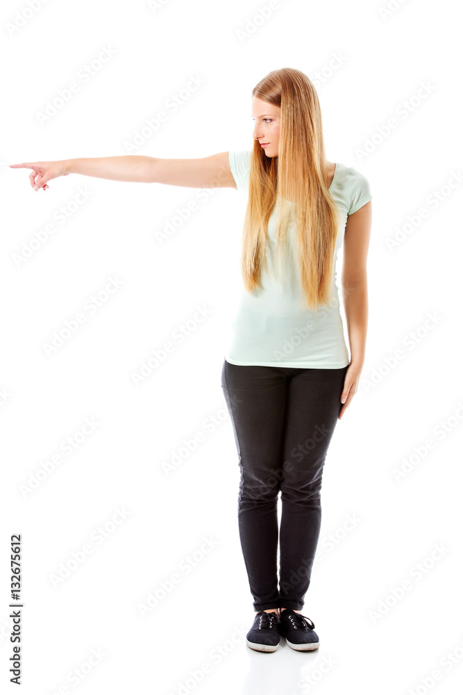 Attractive woman looking and pointing sideways. Attractive woman looking and pointing sideways.