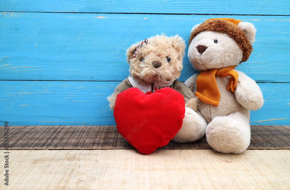Obraz premium Valentine day decoration with brown bear and red heart shape with love text on wooden mock up ,Image for Happy Valentine holiday concept.