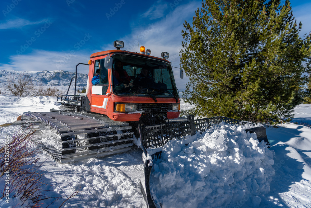 Red ratrack in action - cleaning the road for the skiers Red ratrack in action - cleaning the road for the skiers