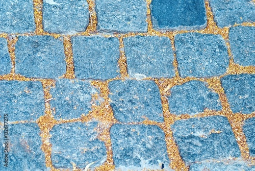 Granite cobblestone pavement background, street in autumn