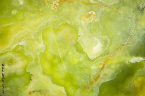 Lightened slices marble onyx. Horizontal image. Warm green colors. Beautiful close up background