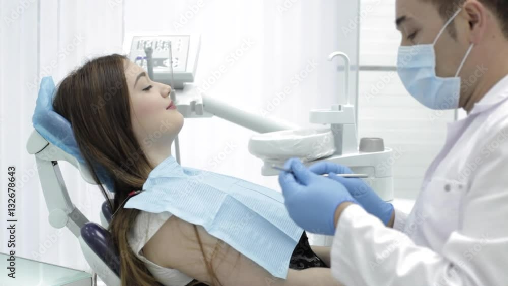 Dentistry. The doctor talks to a patient something funny and patient is smiling. Dentistry. The doctor talks to a patient something funny and patient is smiling.