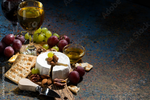 Camembert cheese, snacks and glasses of wine