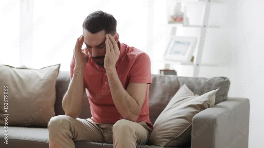 man suffering from headache at home man suffering from headache at home