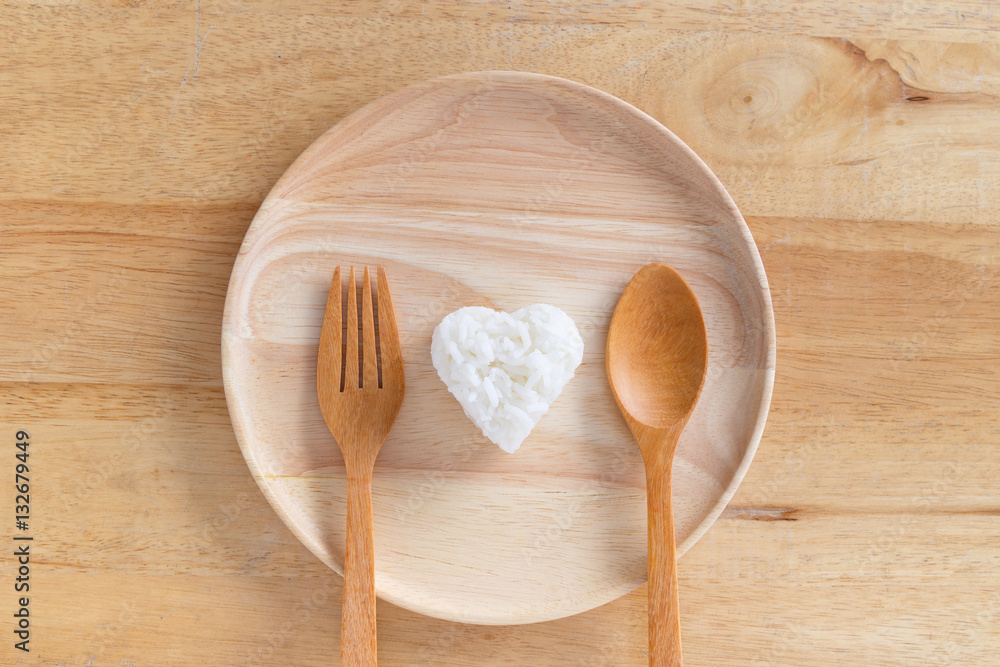 Heart shaped cooked rice in wooden plate. Heart shaped cooked rice in wooden plate.