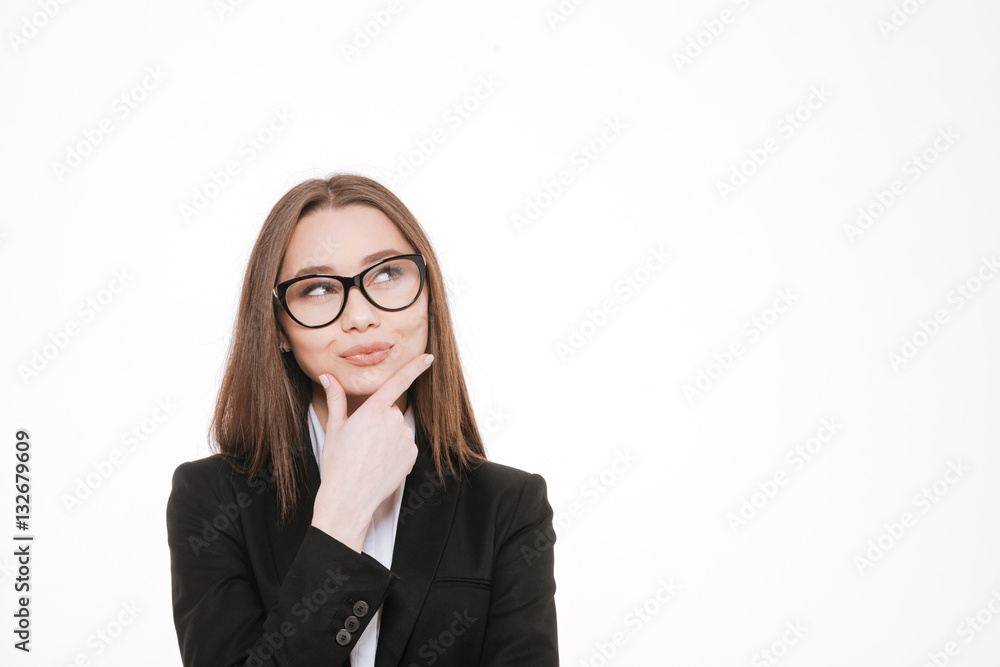 Thoughtful smart businesswoman smiling and looking up at copy space Thoughtful smart businesswoman smiling and looking up at copy space