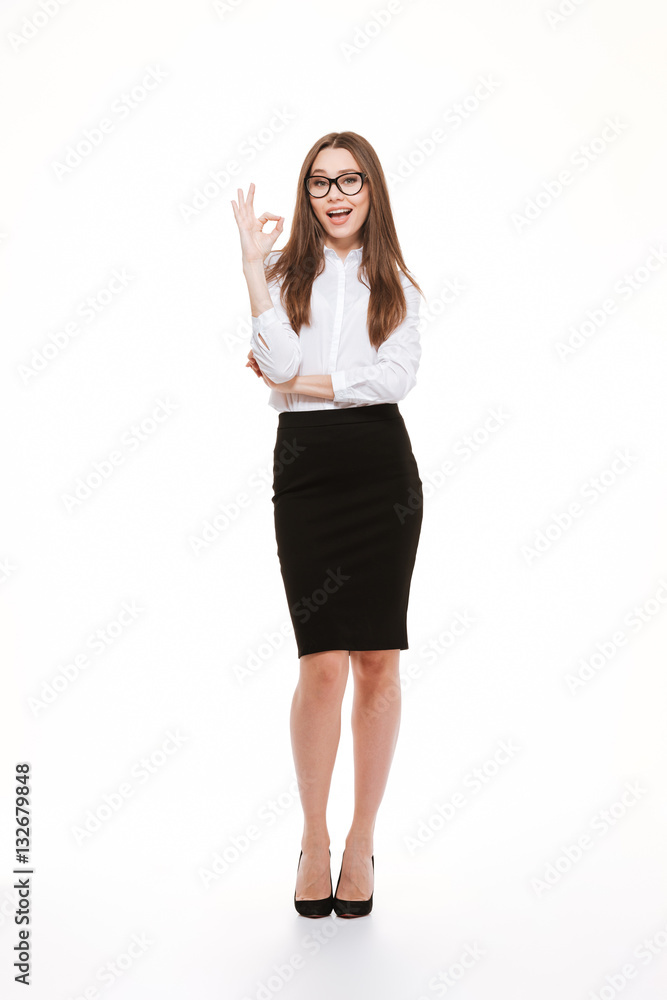 Happy young businesswoman in eyeglasses showing ok sign Happy young businesswoman in eyeglasses showing ok sign