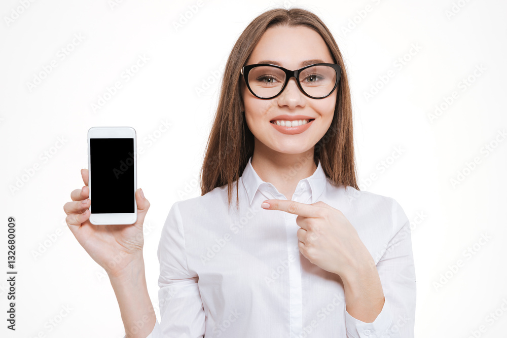 Woman in eyeglasses pointing finger at blank screen mobile phone Woman in eyeglasses pointing finger at blank screen mobile phone