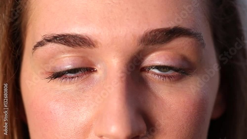 closeup of tired eyes of a beautiful girl falling asleep