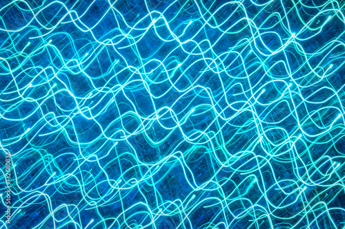 Background with blue blurred magic neon light rays.