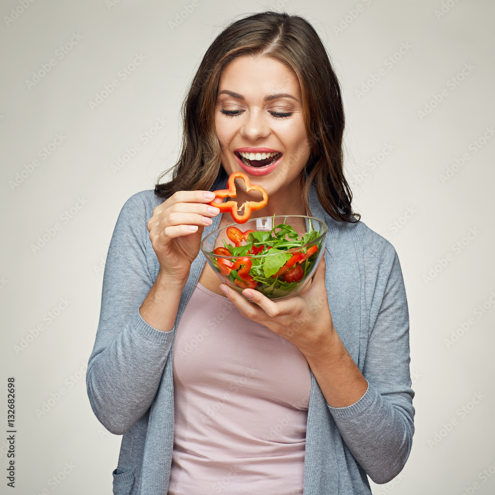 young smiling woman eating salad. young smiling woman eating salad.