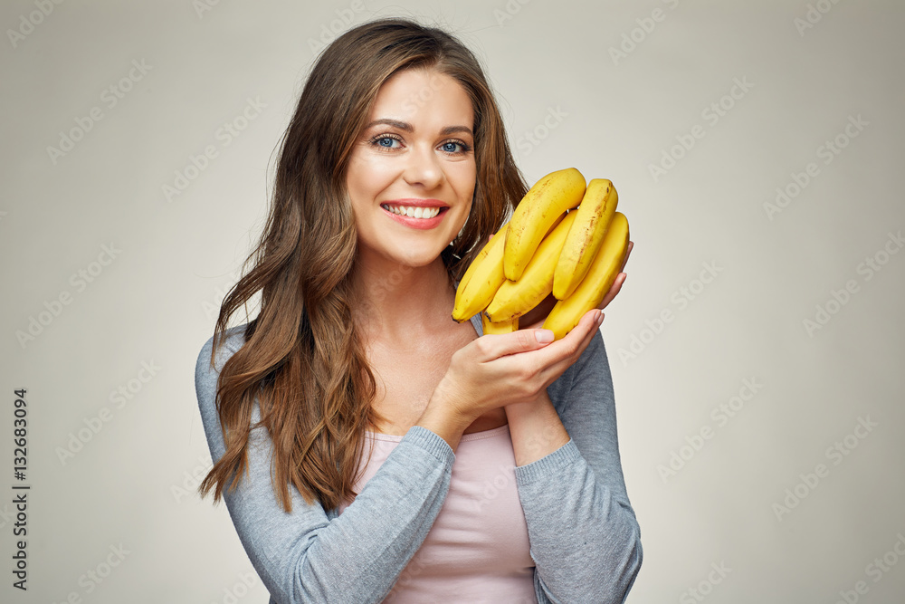 smiling woman with long hair holding banana. smiling woman with long hair holding banana.