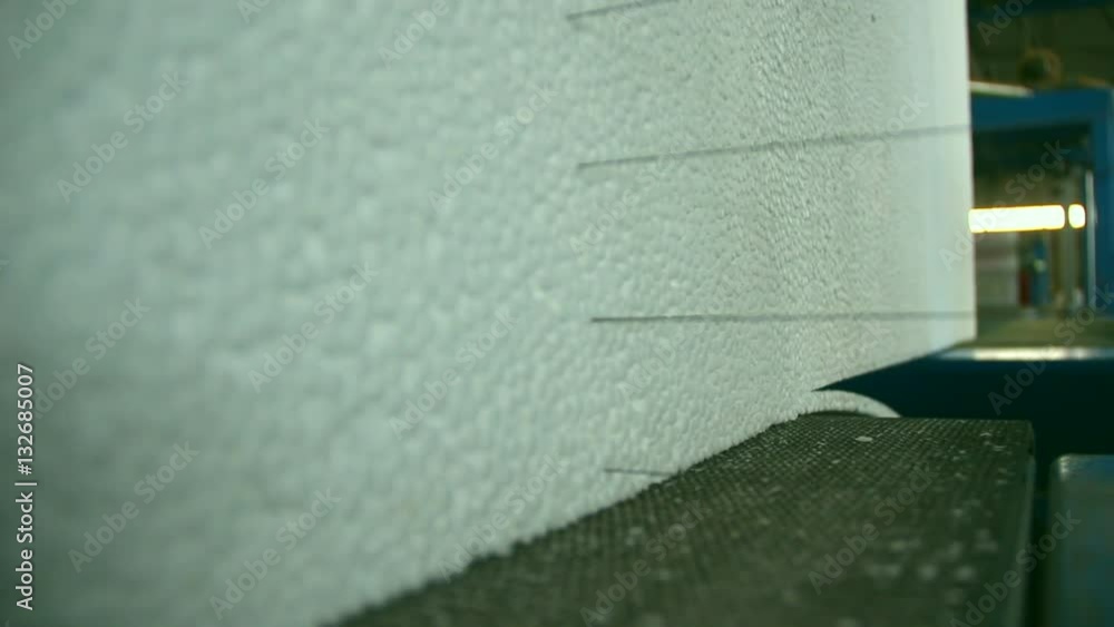 Production of polystyrene, styrofoam in a factory. Cutting of styrofoam
