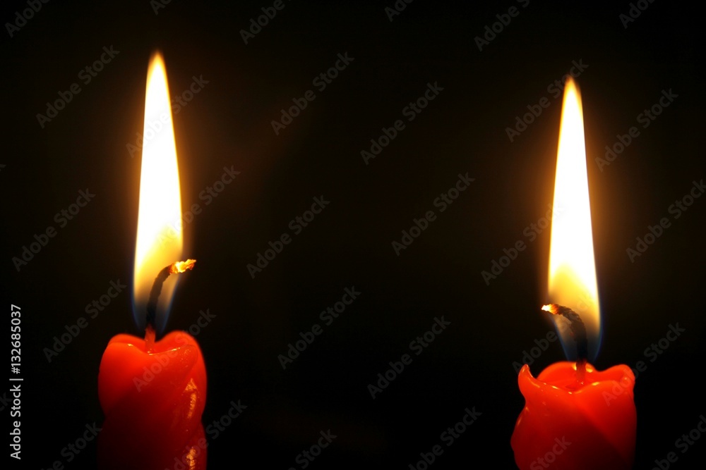 Two red candles burning in the dark Two red candles burning in the dark
