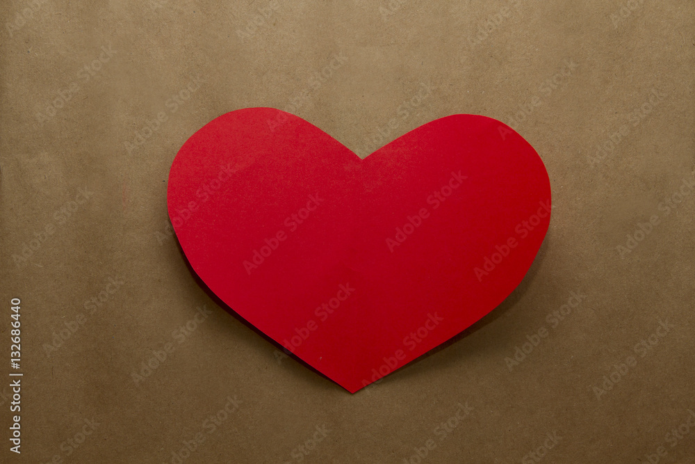 Red paper heart on the brown craft paper background Red paper heart on the brown craft paper background