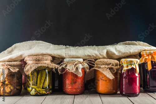 Preserved vegetables on wooden background