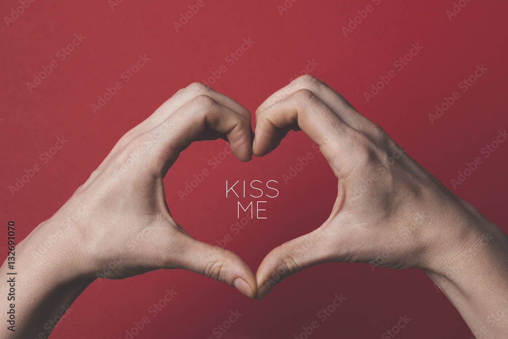 Female hands creating the shape of a love heart around a romantic message. Female hands creating the shape of a love heart around a romantic message.