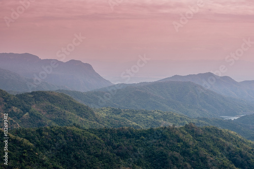 Sunrise landscape of foggy and cloudy mountain valley
