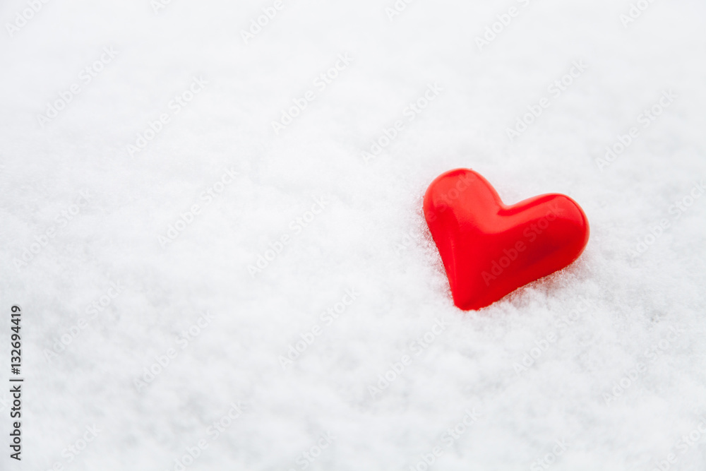Fototapeta premium Ceramic red heart on the fresh snow
