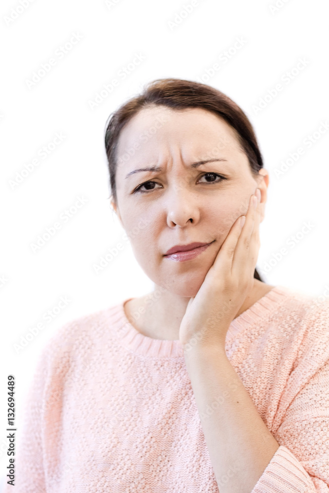 Closeup of young woman suffering from toothache at home. Terrible Strong Teeth Pain, Touching Cheek With Hand. Female Feeling. Dental Care And Health Concept. Closeup of young woman suffering from toothache at home. Terrible Strong Teeth Pain, Touching Cheek With Hand. Female Feeling. Dental Care And Health Concept.