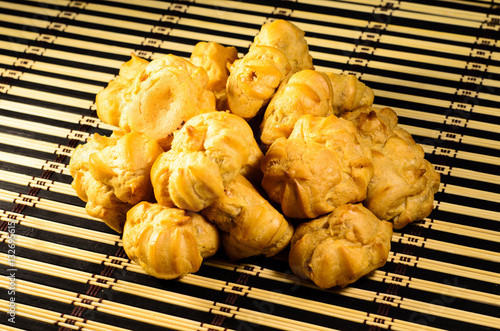 Sweet profiteroles on a bamboo mat photo