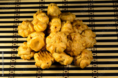 Sweet profiteroles on a bamboo mat photo