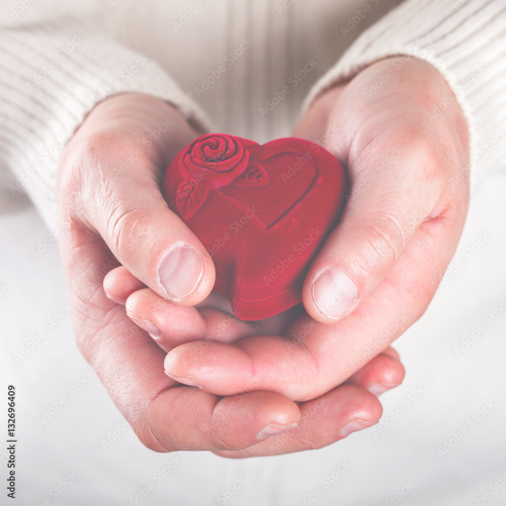Heart,Gift in the Hands of Men. Offer Love To A Woman.Holiday Valentine's Day.Wedding.toned image..selective focus. - obrazy, fototapety, plakaty 