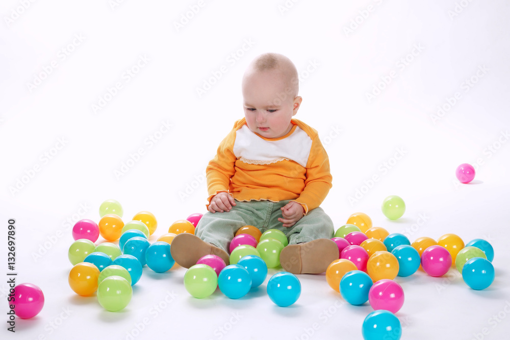 Fototapeta premium cute crying girl with many colorful balls