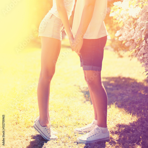 Summer happy young couple in love kissing outdoors, colorful sun © guas