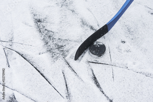 Hockey stick and puck on ice
 photo