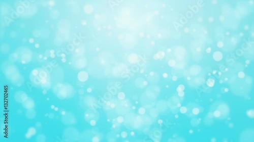 Festive turquoise blue bokeh background with flickering light particles imitating underwater bubbles.