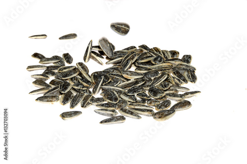 Closeup of black baked sunflower seeds isolated on white background