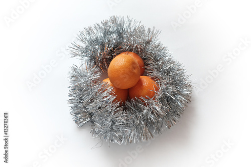 Oranges in Christmas foil isolated on white