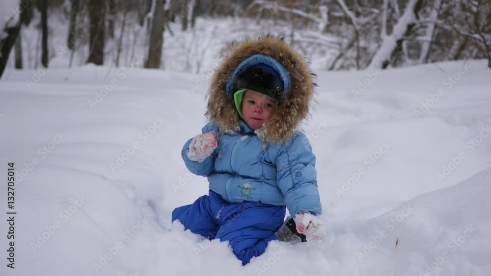 a funny child plays in the snow a funny child plays in the snow