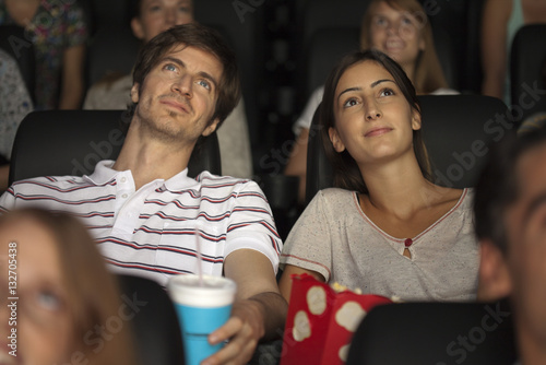 Couple enjoying movie in theater photo