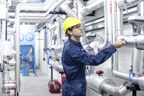 Engineer working in industrial plant photo