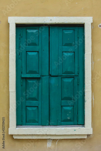  vintage closed wooden window on grunge wall background © orathai