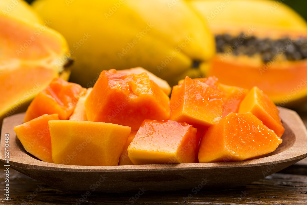 Sliced fresh papaya on wooden background Sliced fresh papaya on wooden background