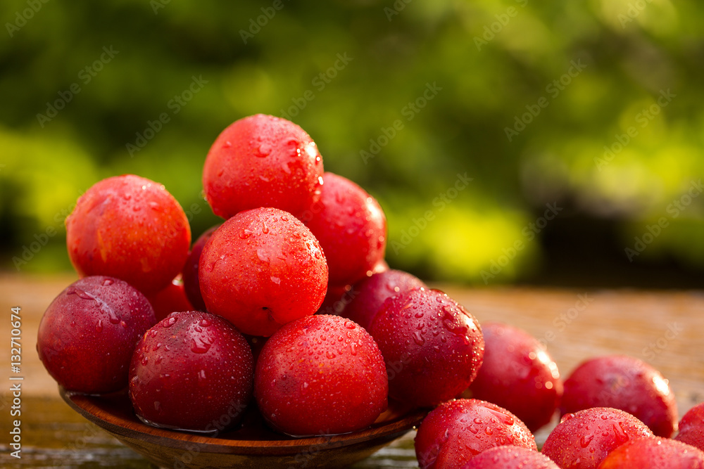 Fresh bright plums on wooden background Fresh bright plums on wooden background