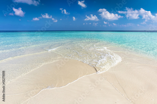 Tropical beach with white sand and clear turquoise ocean. Maldives