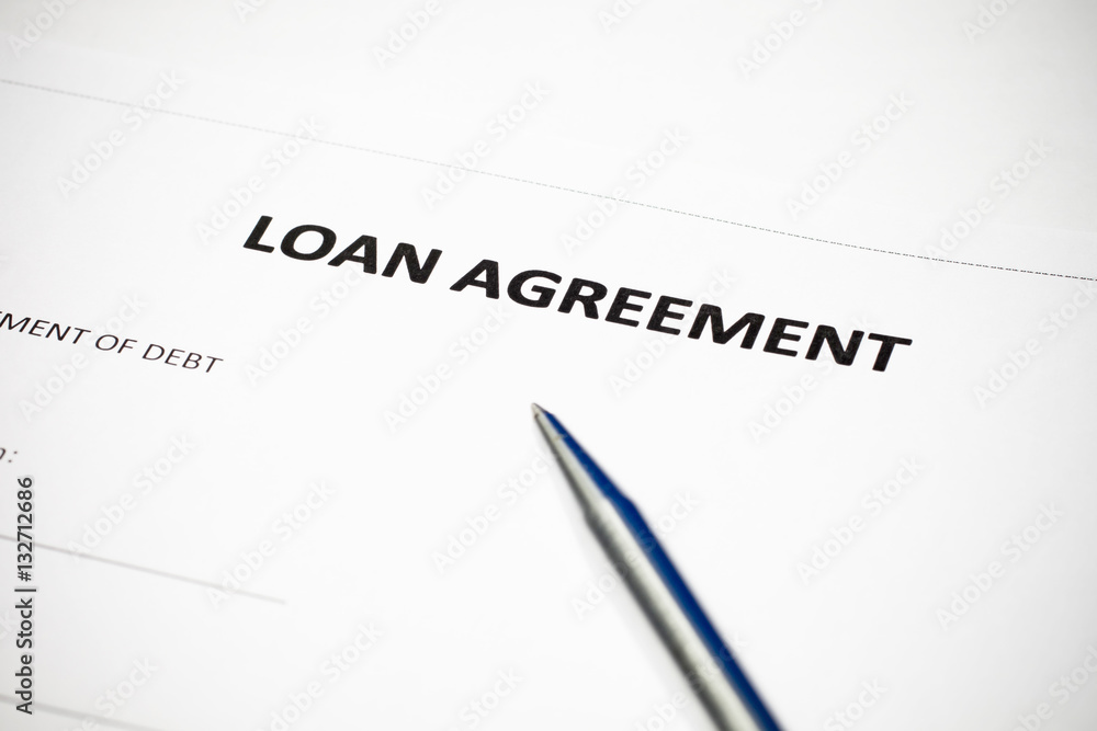 Loan agreement document with pen