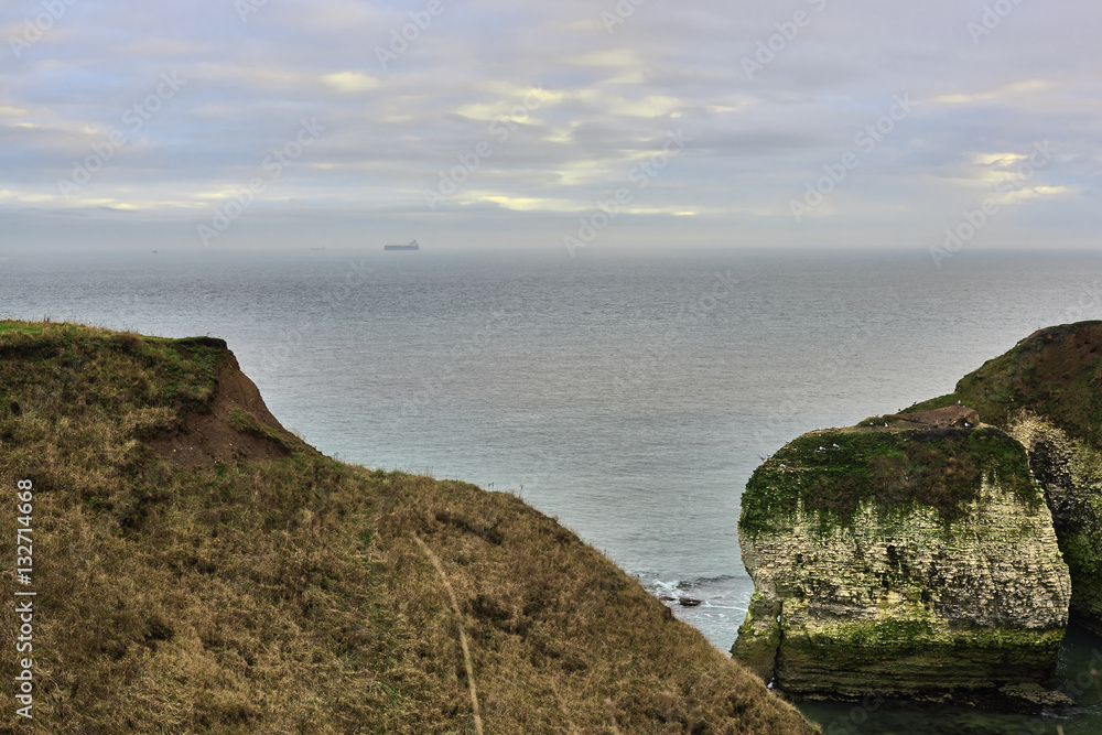 A view of the beach and surrounding rock at the North Landing at Flamborough Head on the north Yorkshire coast.