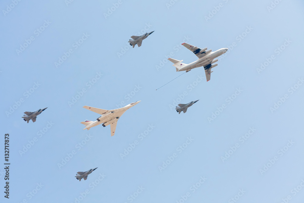 Il-78 refueling tanker with Tu-160 strategic bomber and Mig-31 supersonic interceptors fly against blue sky background
Il-78 refueling tanker with Tu-160 strategic bomber and Mig-31 supersonic interceptors fly against blue sky background