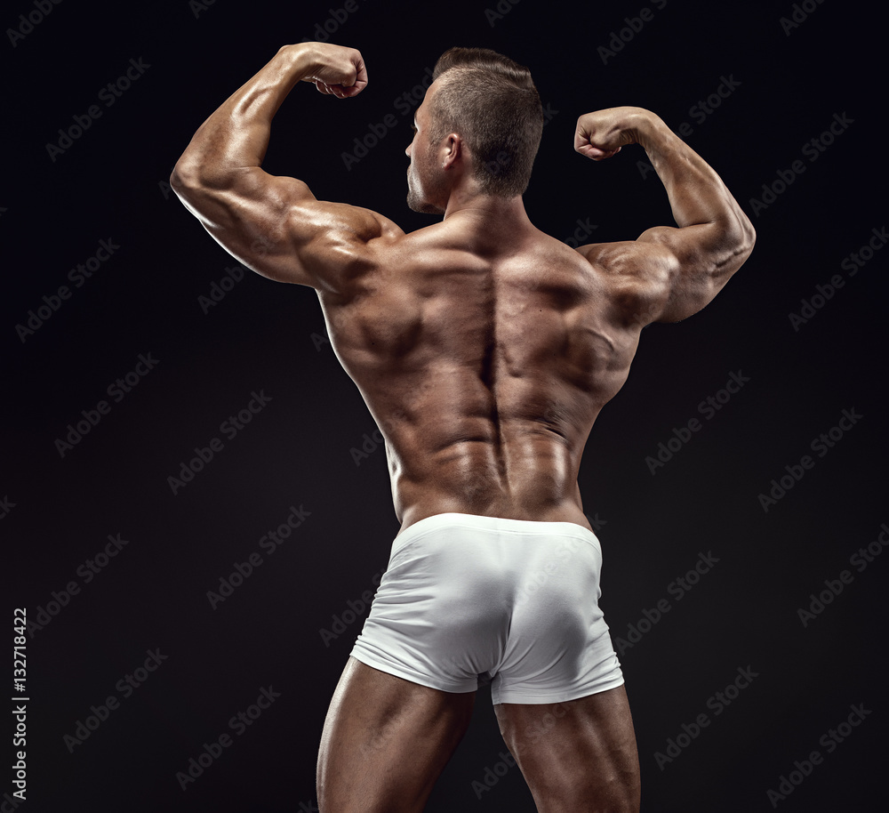 Strong Athletic Man Fitness Model posing back muscles, triceps,