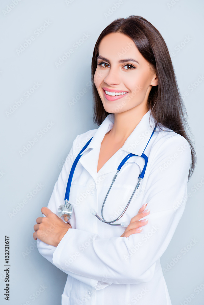 Portrait of young happy female doctor with crossed hands Portrait of young happy female doctor with crossed hands