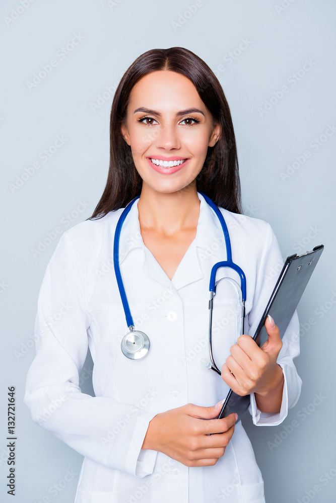 Happy young nurse holding folder isolated on lue background Happy young nurse holding folder isolated on lue background