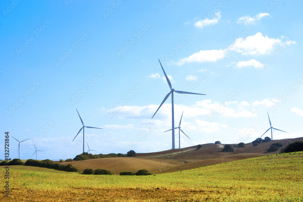 Wind turbines on the green hills of Andalusia at the midday Wind turbines on the green hills of Andalusia at the midday
