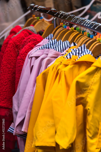 Bright raincoats hanging at a fashion store